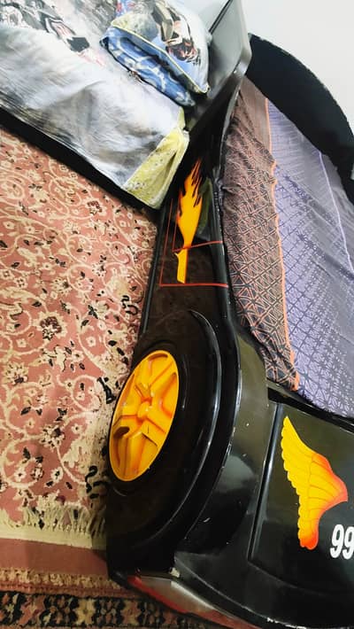 Single car bed for teen boys with matching toy tack