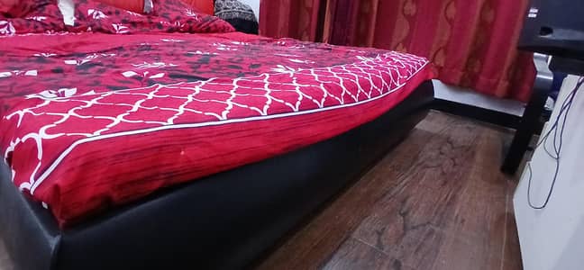 black and red leather bed with 2 sidetables