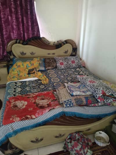 double bed with side tables and dressing table