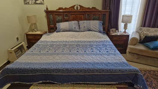 Wooden carved bed with side tables, dressing table, mirror and stool
