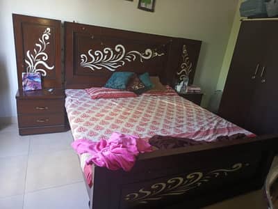 king size wooden bed with side tables