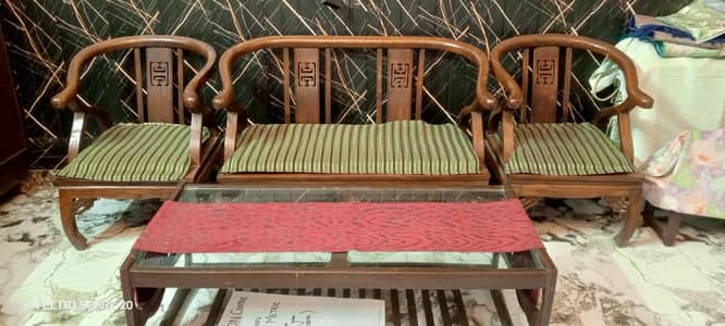 wooden sofa chairs with wooden glass table.