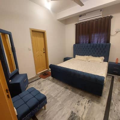 wooden cushion bed with side table and dressing table