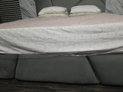 quilted king size bed with 2 sidetables