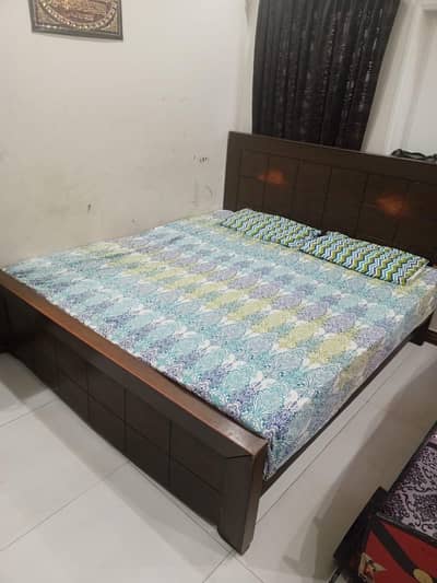 double bed with side tables and dressing table