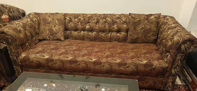 Slightly usEd 5 seater sofa with golden brown mixed print