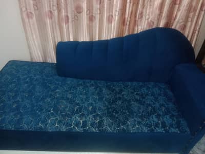 modern royal blue deewan couch with a patterned textured fabric seat.