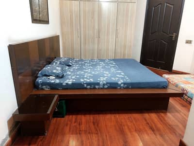 Solid, heavy, wooden bed with side tables for sale without matress.
