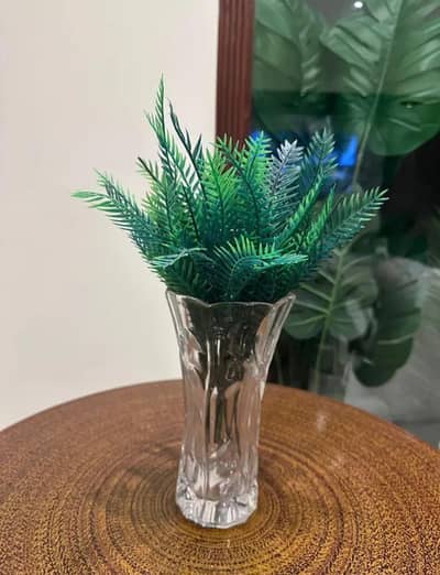 white glass vase with leaves