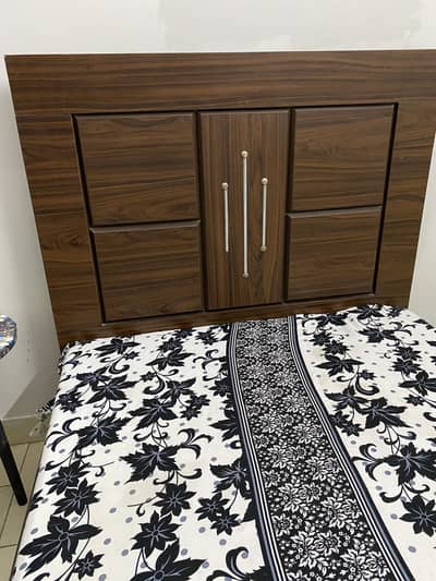 Single bed without mattress along with dressing table