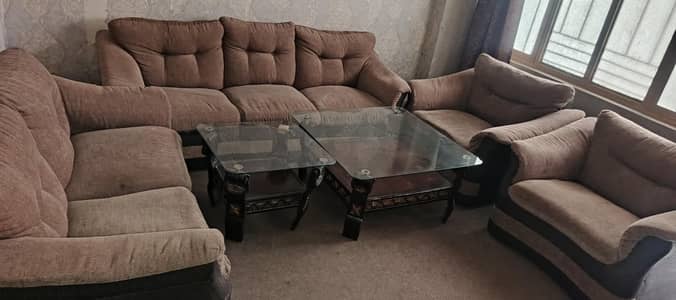 sofa set 7 seater in a good condition with covers and 2 tables