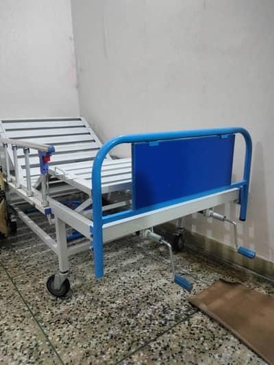 unused manual patient stretcher bed. with table and side railings