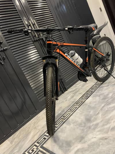 Black and orange colour mountain bike