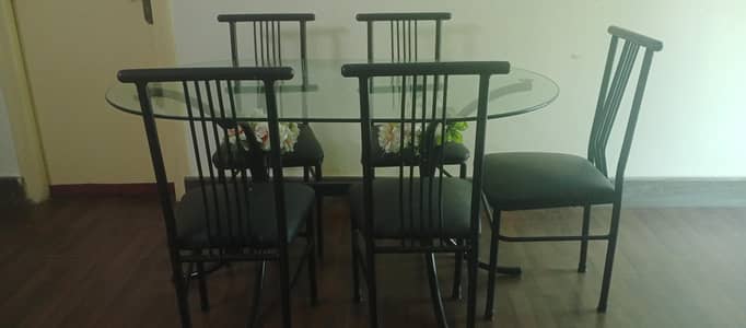used iron glass top oval table with six chairs