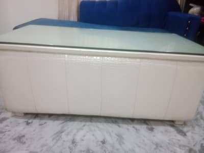 modern white leather  center table with a glass top