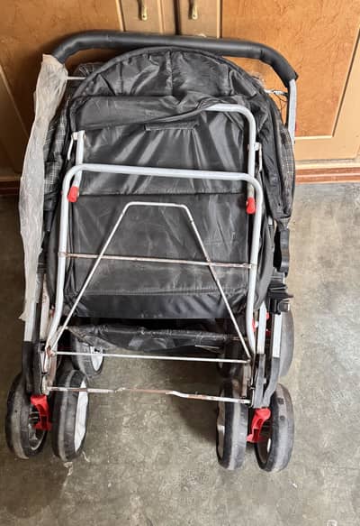 Baby stroller with locks and foot placing