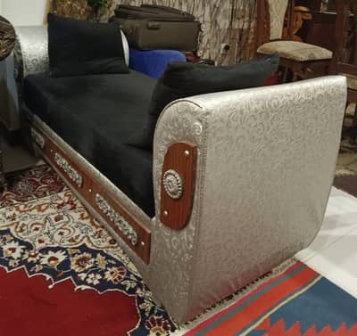 Backless black and silver combination deewan sofa with cutions