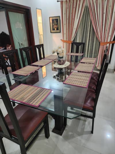 8 seater dinning table wood based with glass top