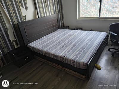 Queen size bed with one side table