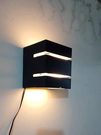modern wall lamp with gold light . dark brown MDF