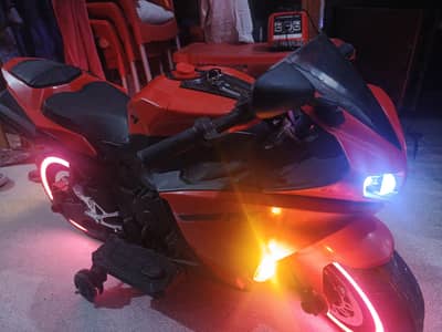 This is a red Kids R1 Electric Ride-On Motorcycle. / mini bike for kid