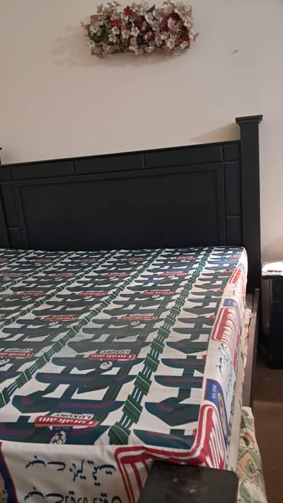 matte black bed along with mattress