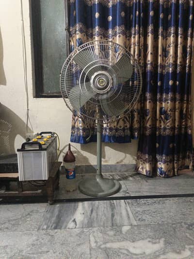 a pedestal fan for sale in just 11999/ PKR, it's in good condition