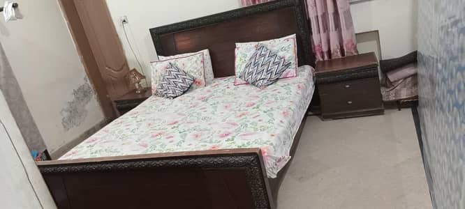 wooden bed with side table