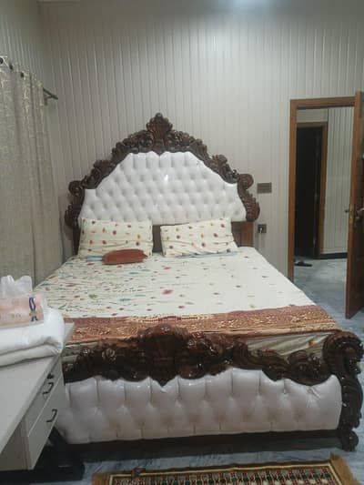 King sized bed with two bed sides without mattress