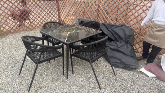 Outdoor Black Table with chairs. Marble top