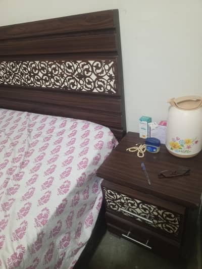 Used wooden bed with mattress
