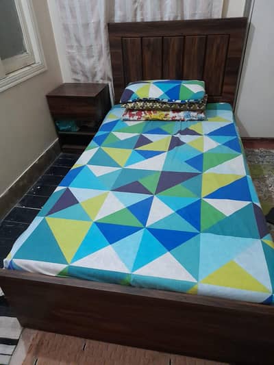 single bed with side table