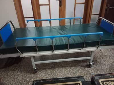 Hospital patient bed with side guards and mattress