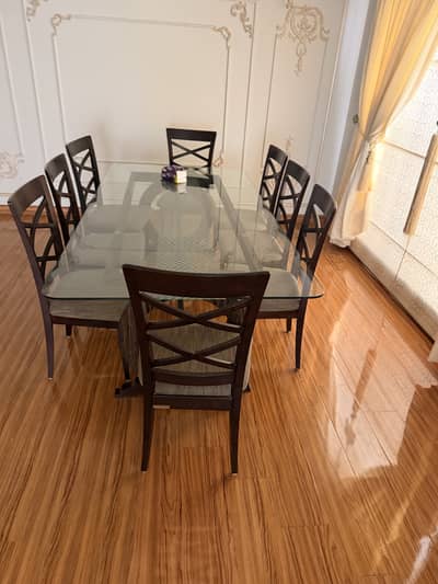 Its slightly used interwood dinning table with 8 chairs like brand ne