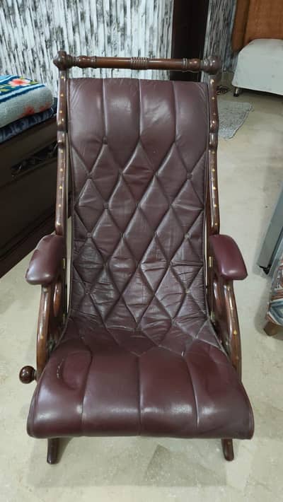 Peshawari Handicrafts rest chair with a brown leather cushion.