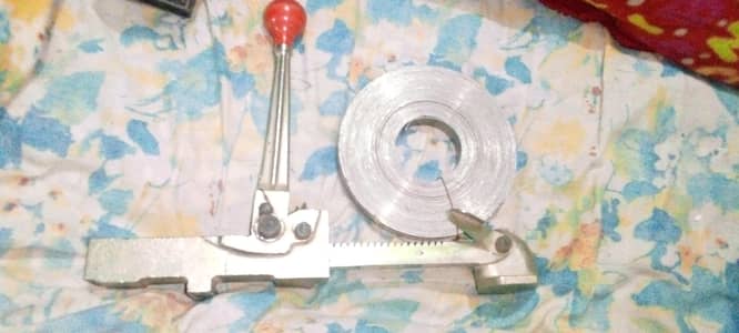 Steel strapping tensioner with coil