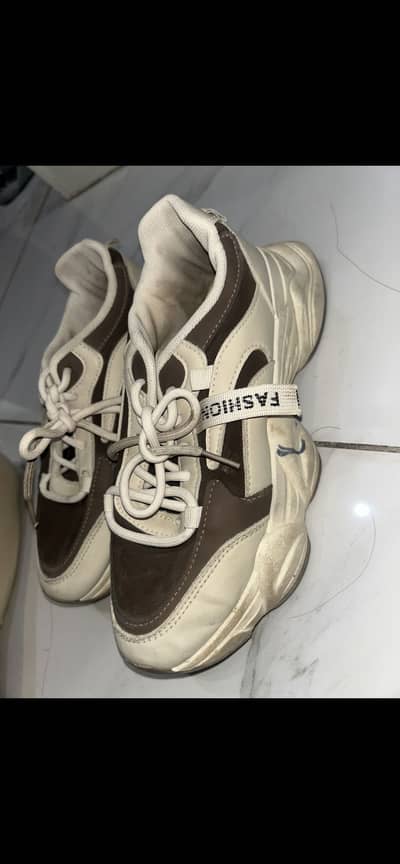 High sole brown and white shoes