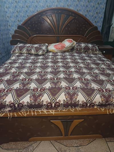 wooden king size bed. 2 bedsides and a drawer at head end.
