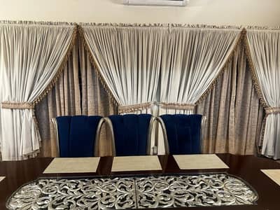 curtains  and dininh table with 8 chairs