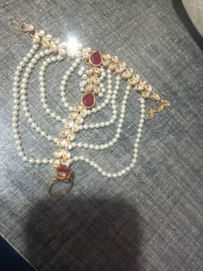 Artificial bracelet in white and mehroon contrast for sale