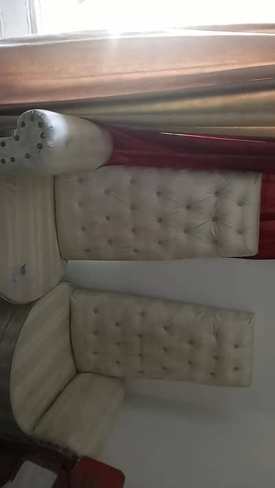 two white chairs with one small table