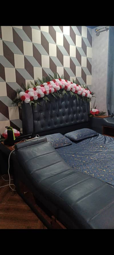 double bed with massager and side lights and draws