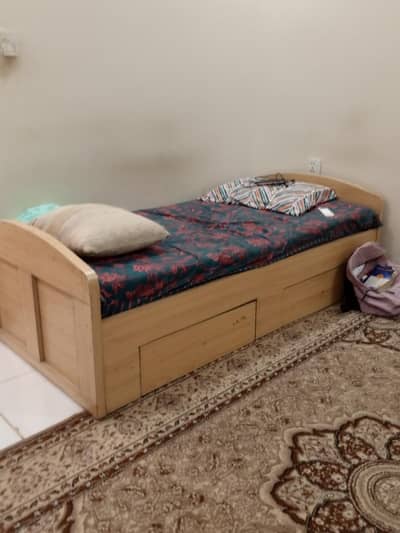 wooden single bed with drawers