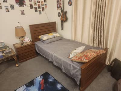wooden single bed with side table