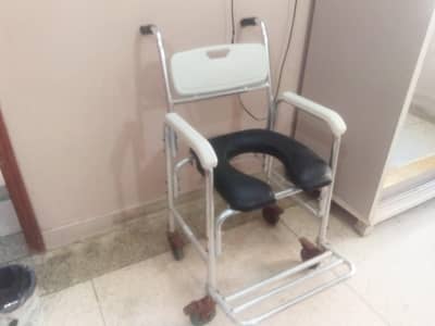 4 in 1 commode wheel chair with a chrome frame and wheel