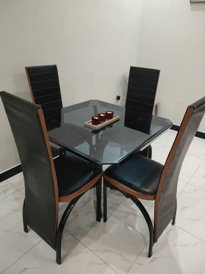 Glass dining table with solid iron base