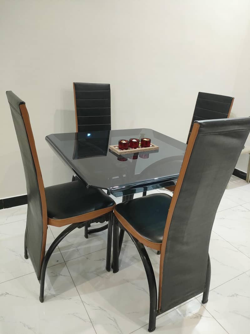 Glass dining table with solid iron base 1
