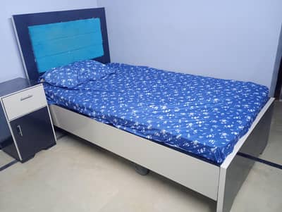 Almost new single wooden ply bed with side table