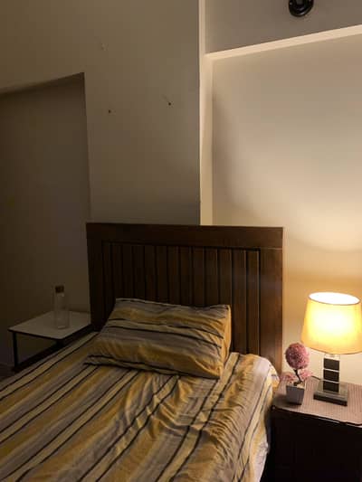 Single bed with thick spring matress and side table