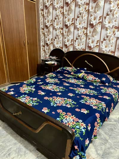 Wooden double bed with side tables.